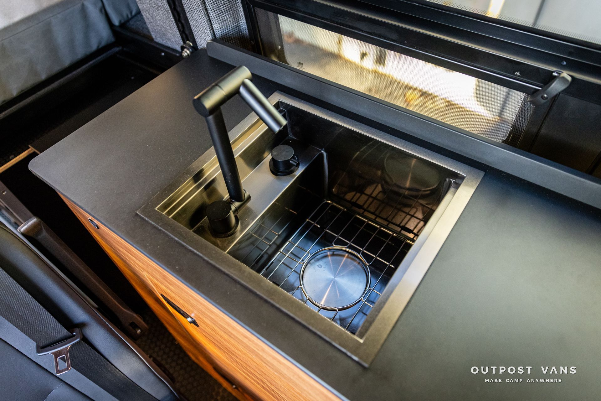 a kitchen with a sink and a stove top oven .