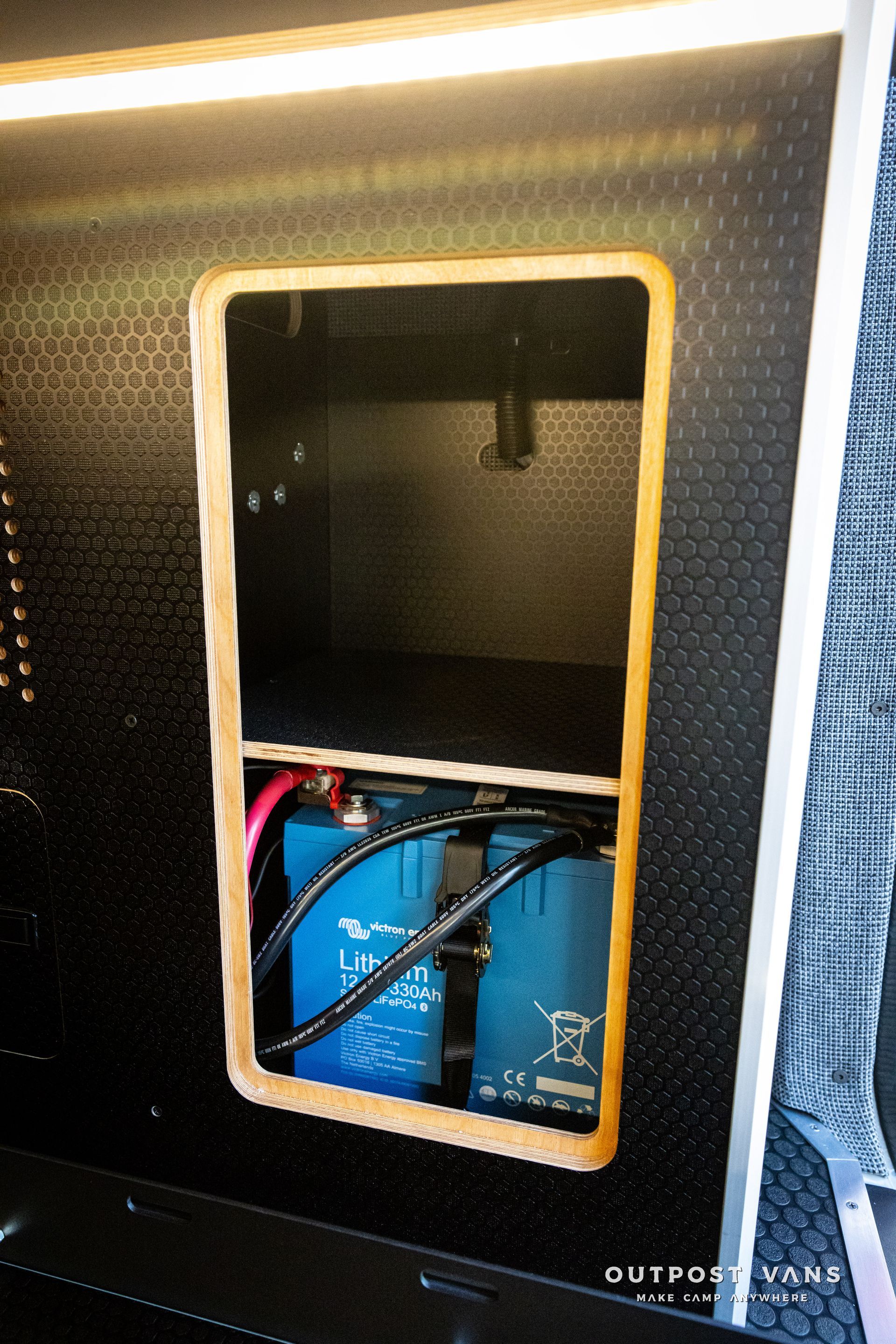 two blue batteries are sitting inside of a black box .