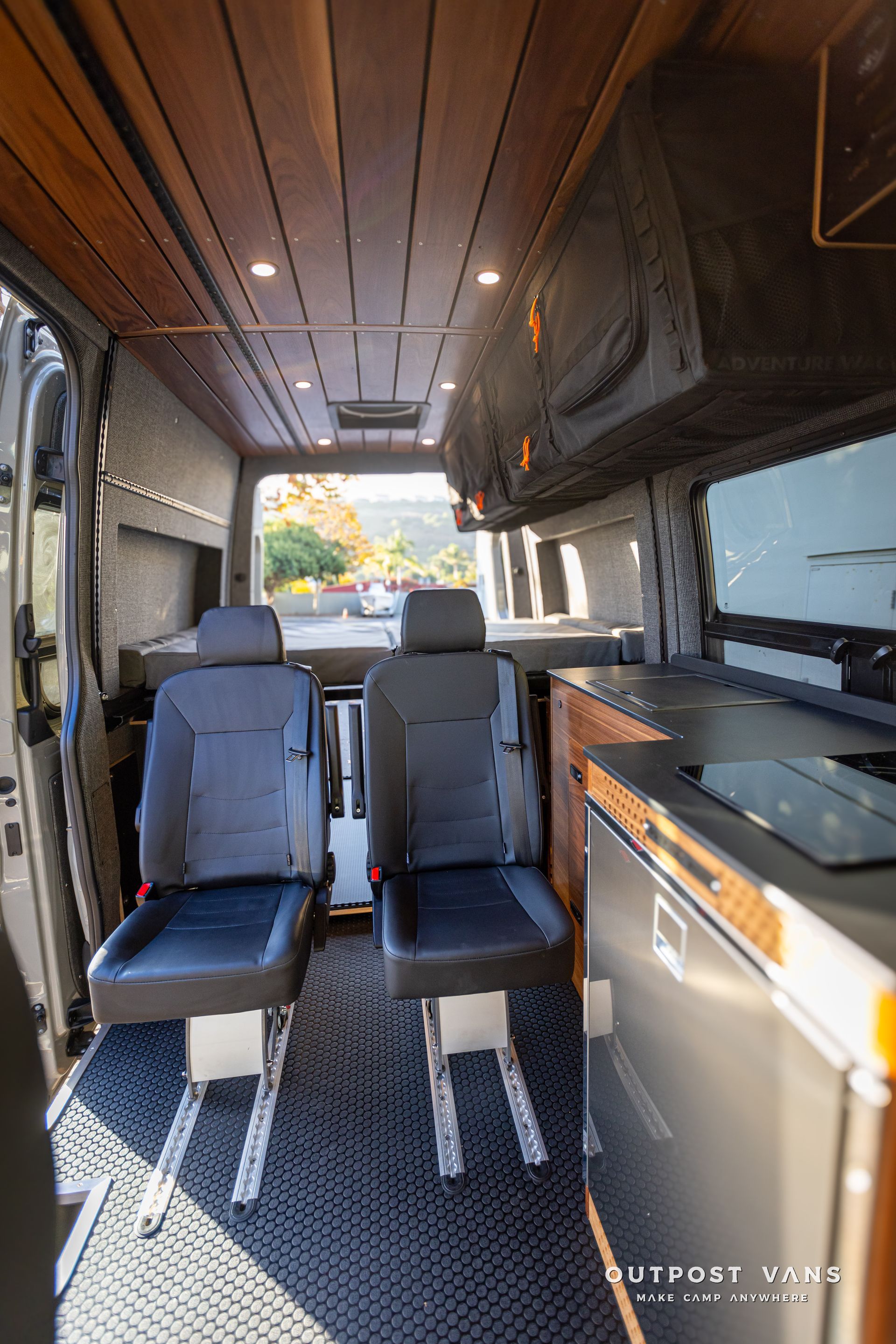 the inside of a van with two seats and a kitchen .