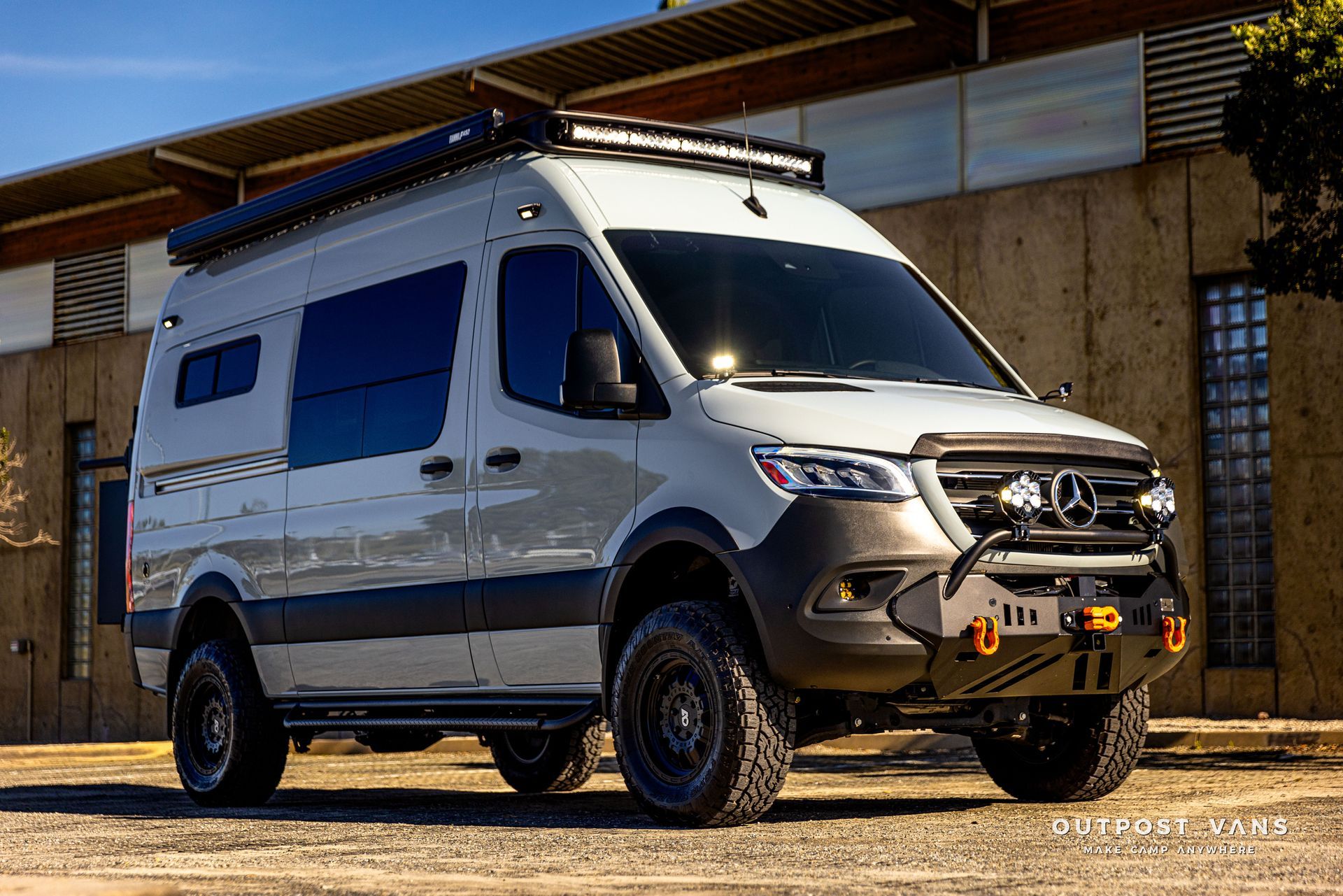 a white van is parked in front of a building .