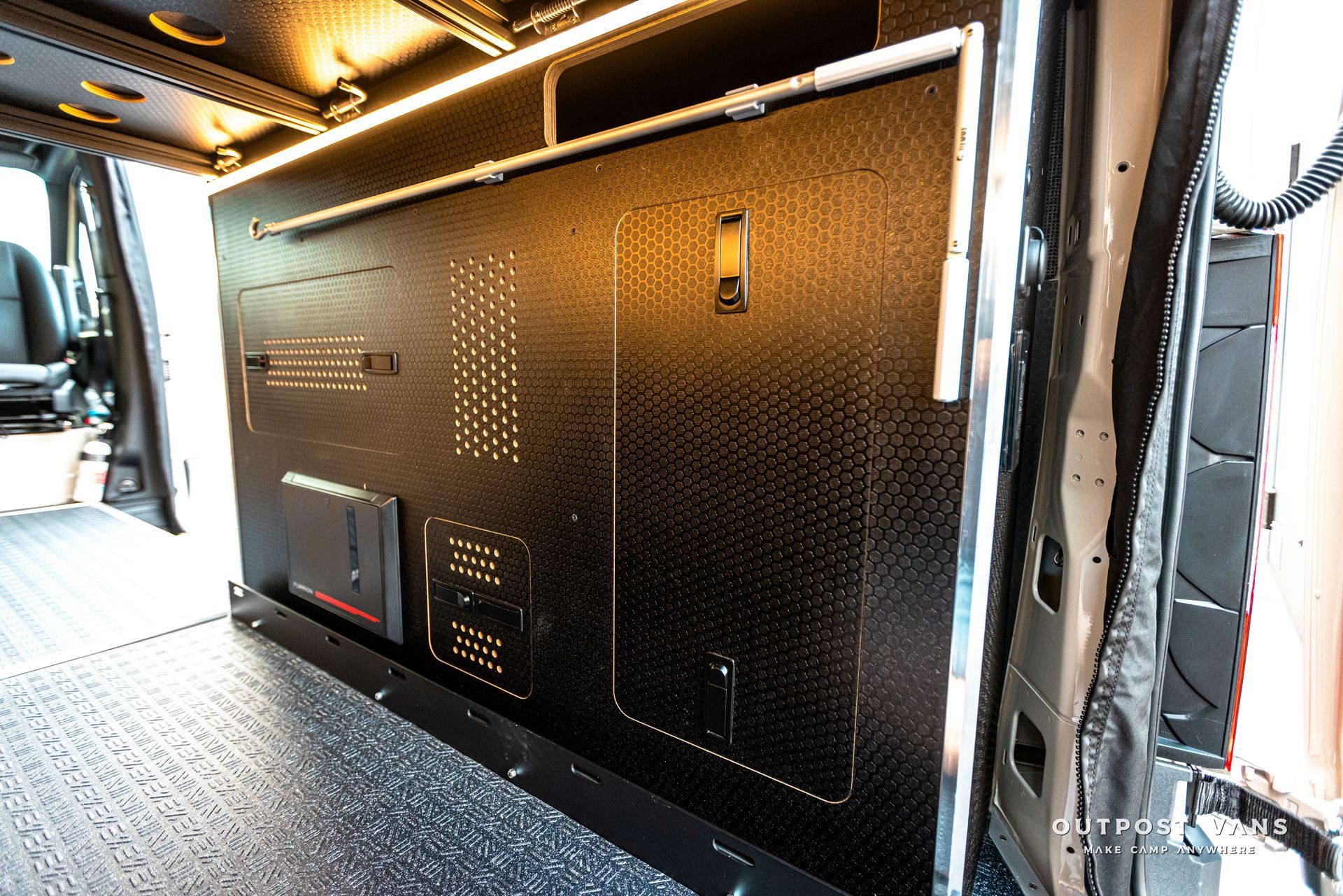 The back of a van with a tv mounted on the wall.