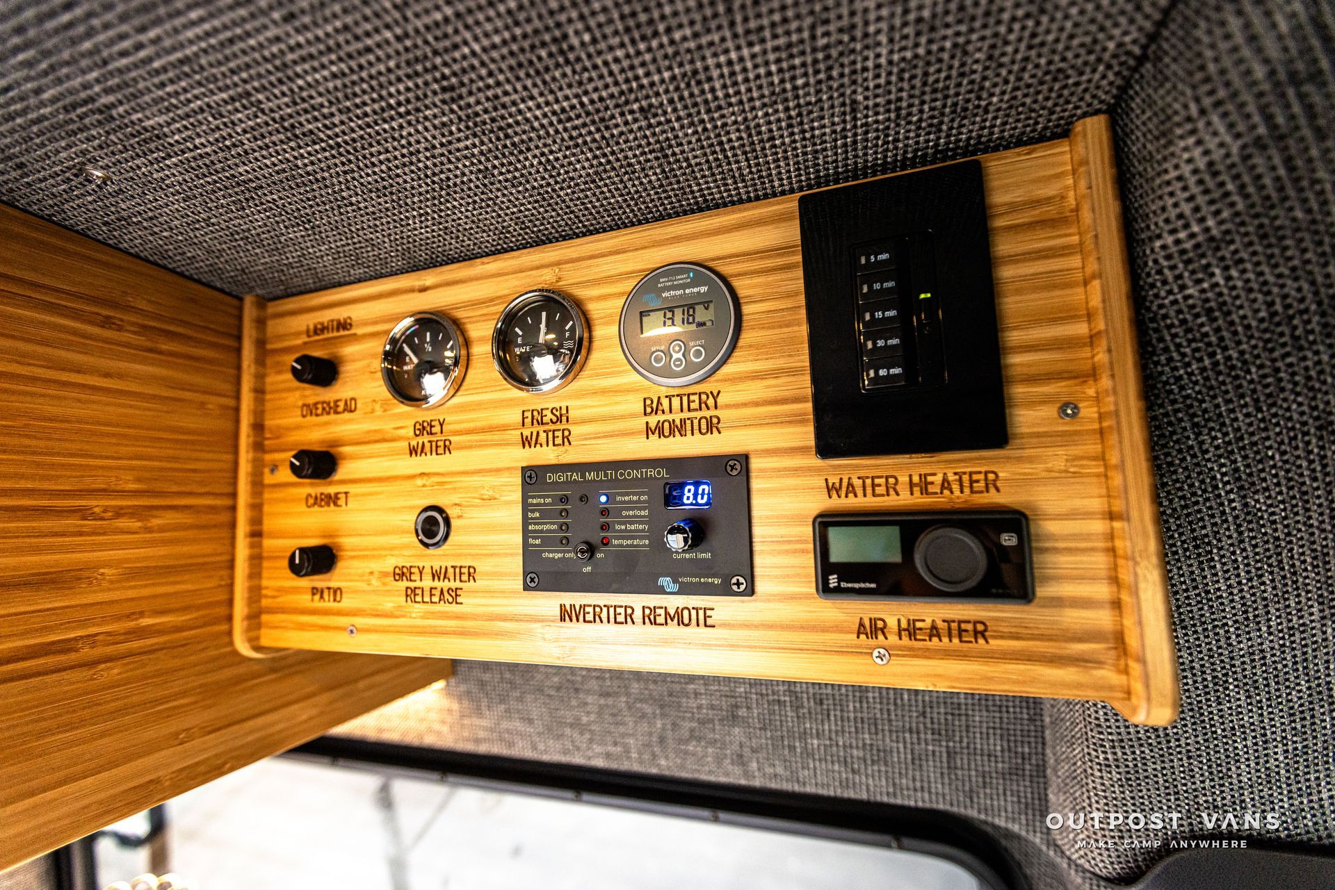 A wooden dashboard with a lot of buttons and switches on it.