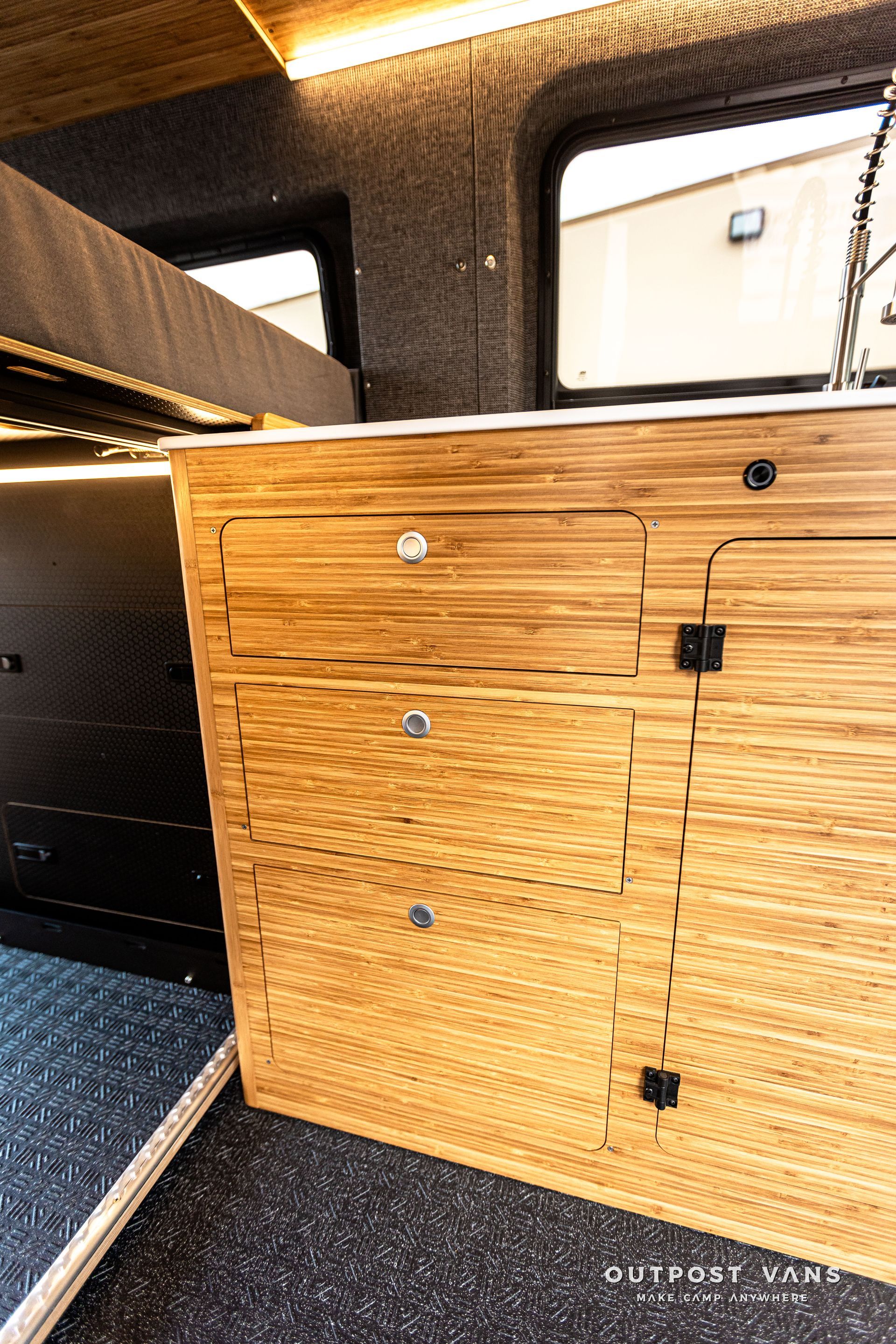 A close up of a wooden cabinet in a van.
