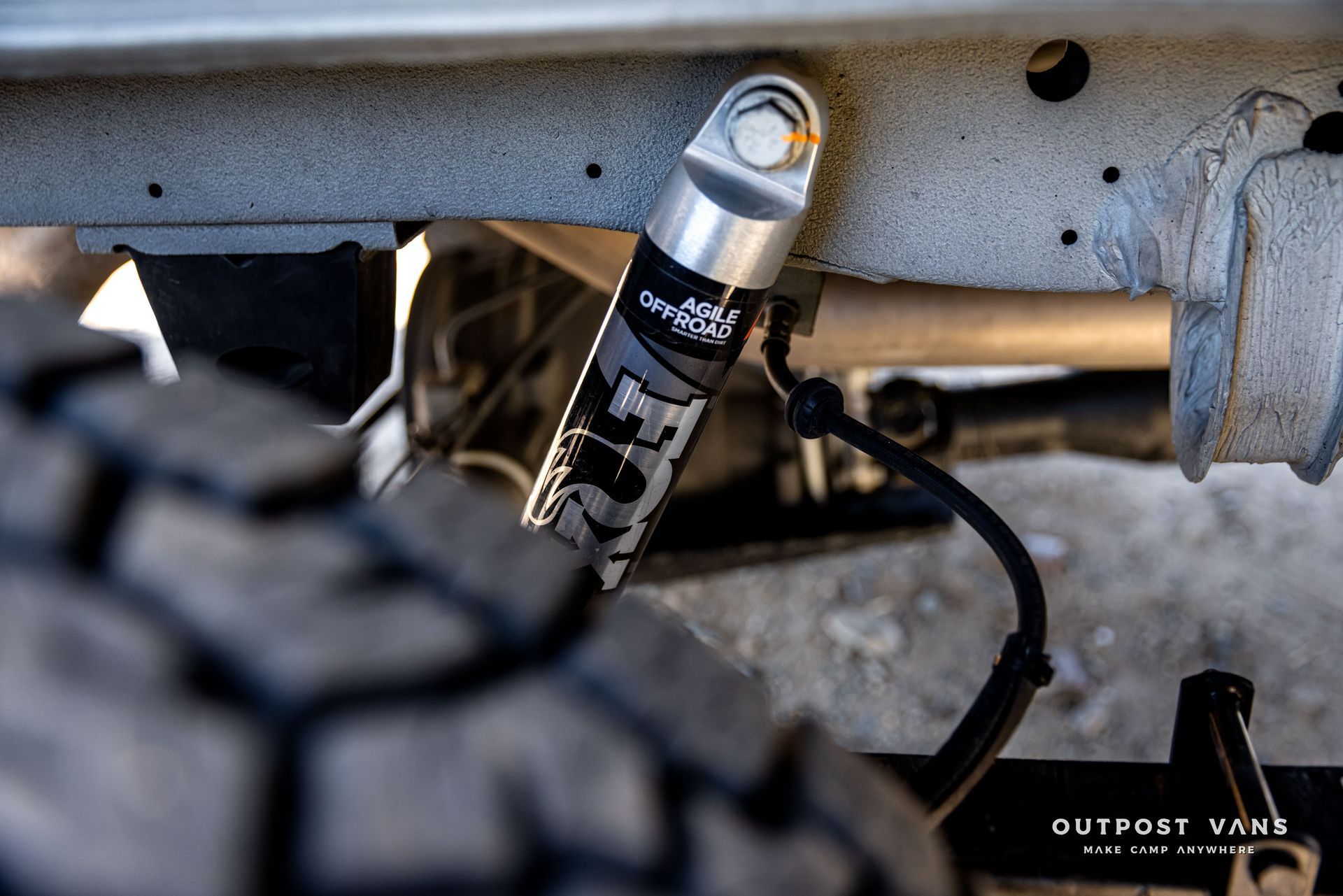 A close up of a shock absorber on a truck.