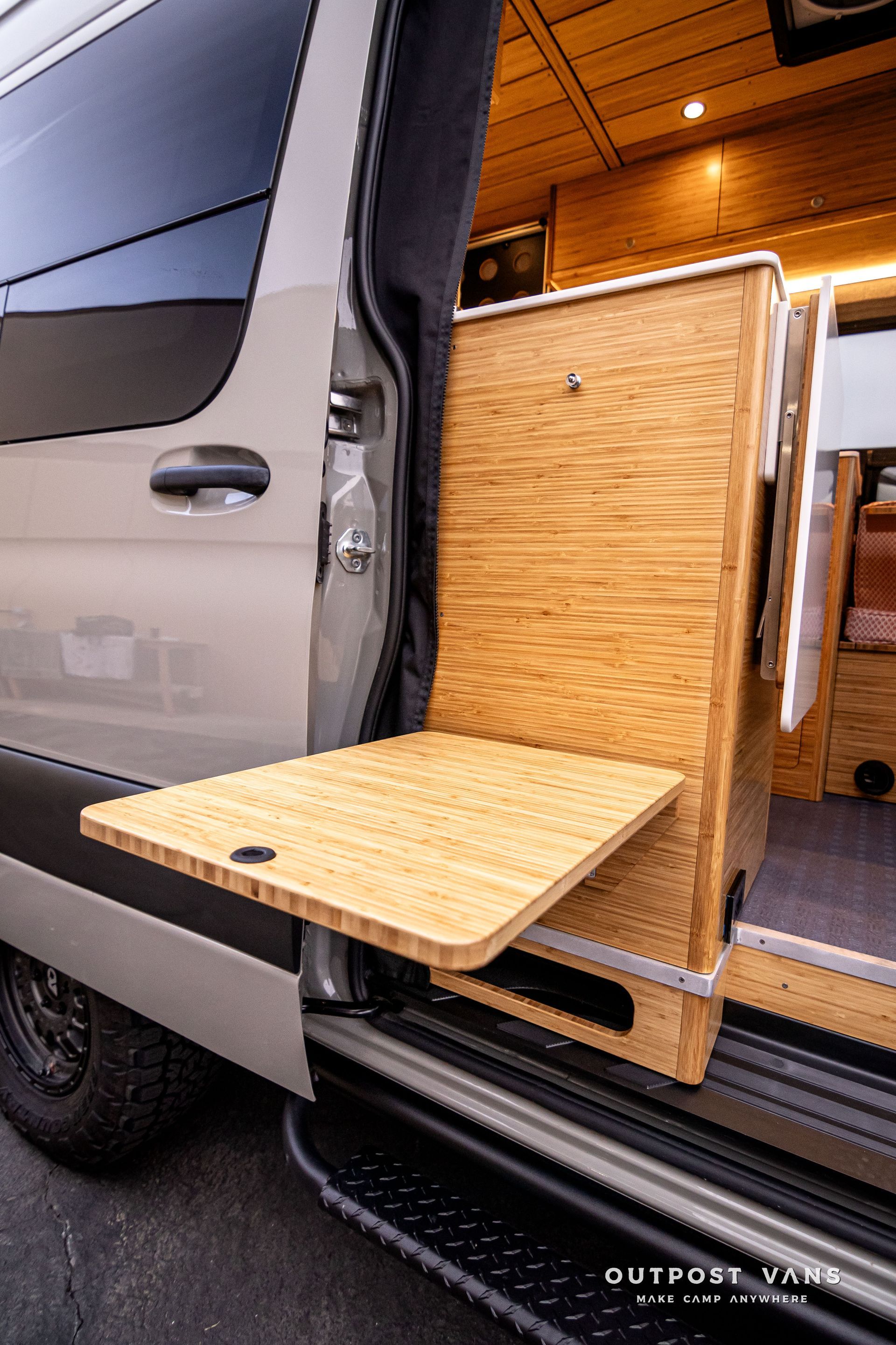 A van with a wooden table attached to the side of it.