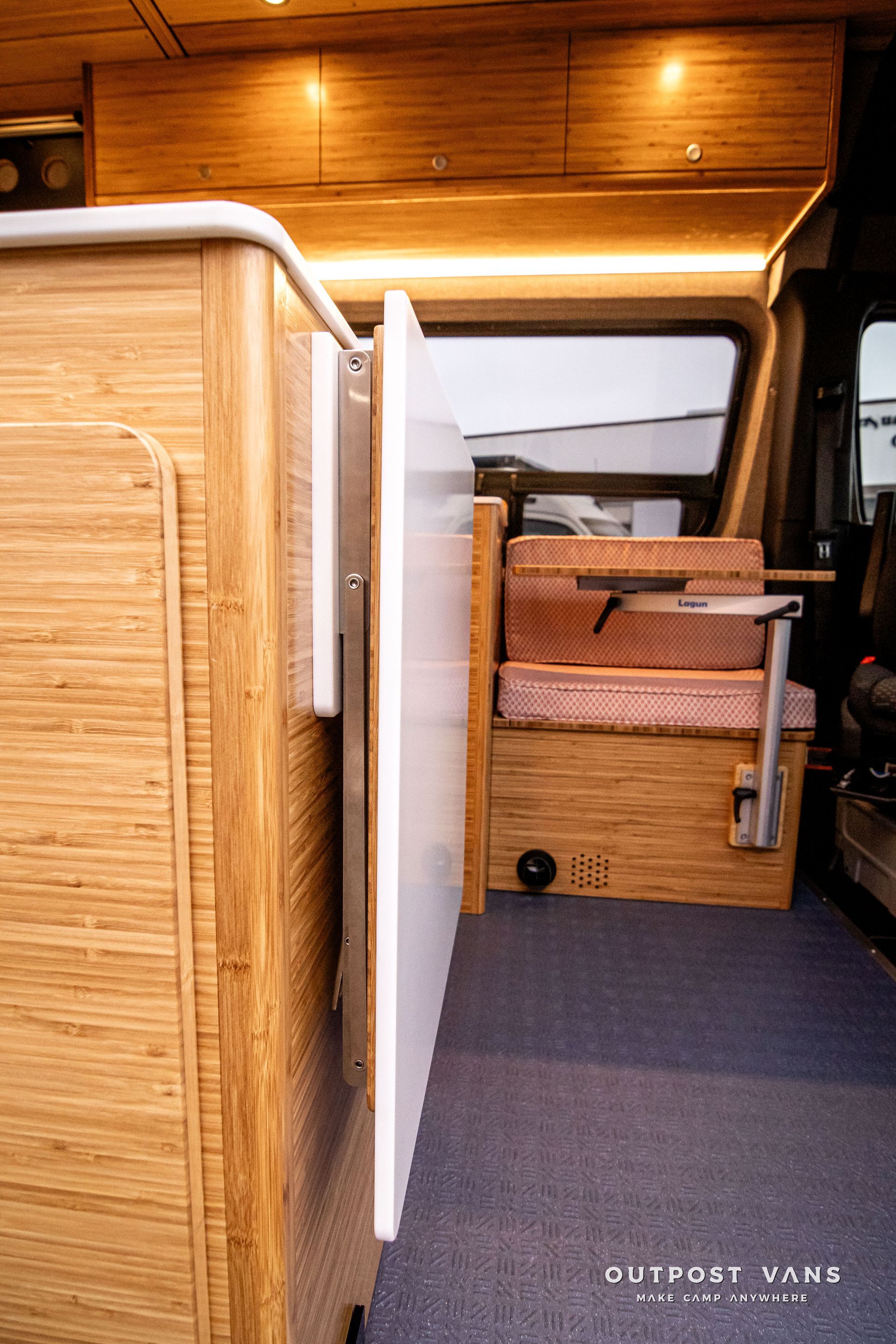 The inside of a camper van with a table and chairs.