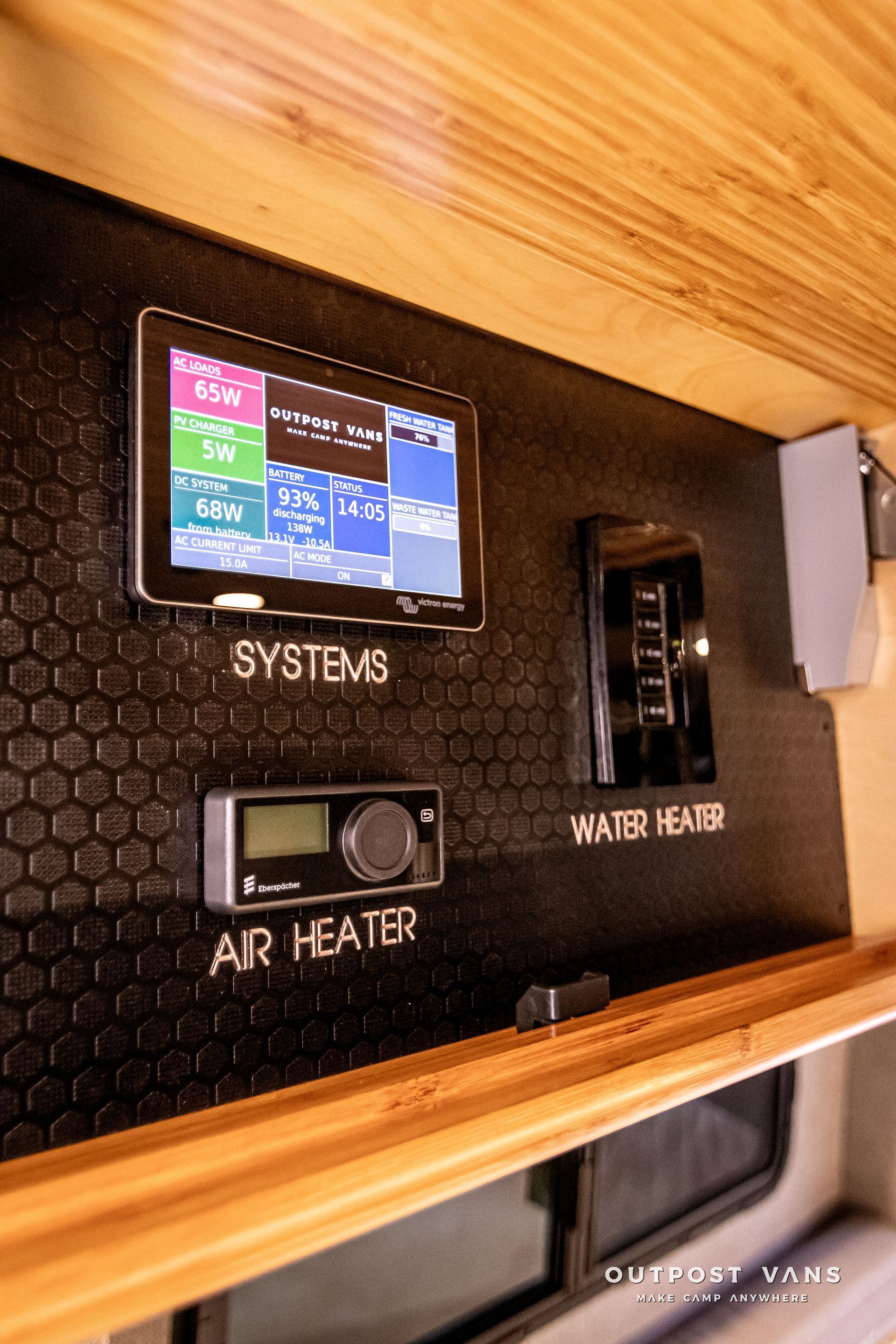 A tablet is sitting on a wall next to a air heater.
