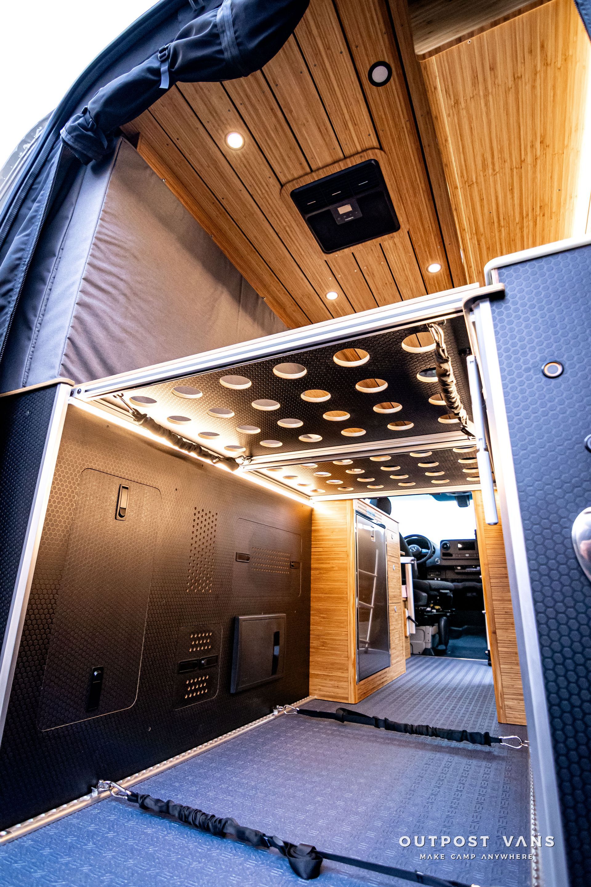 The inside of a van with a ceiling fan and lights.