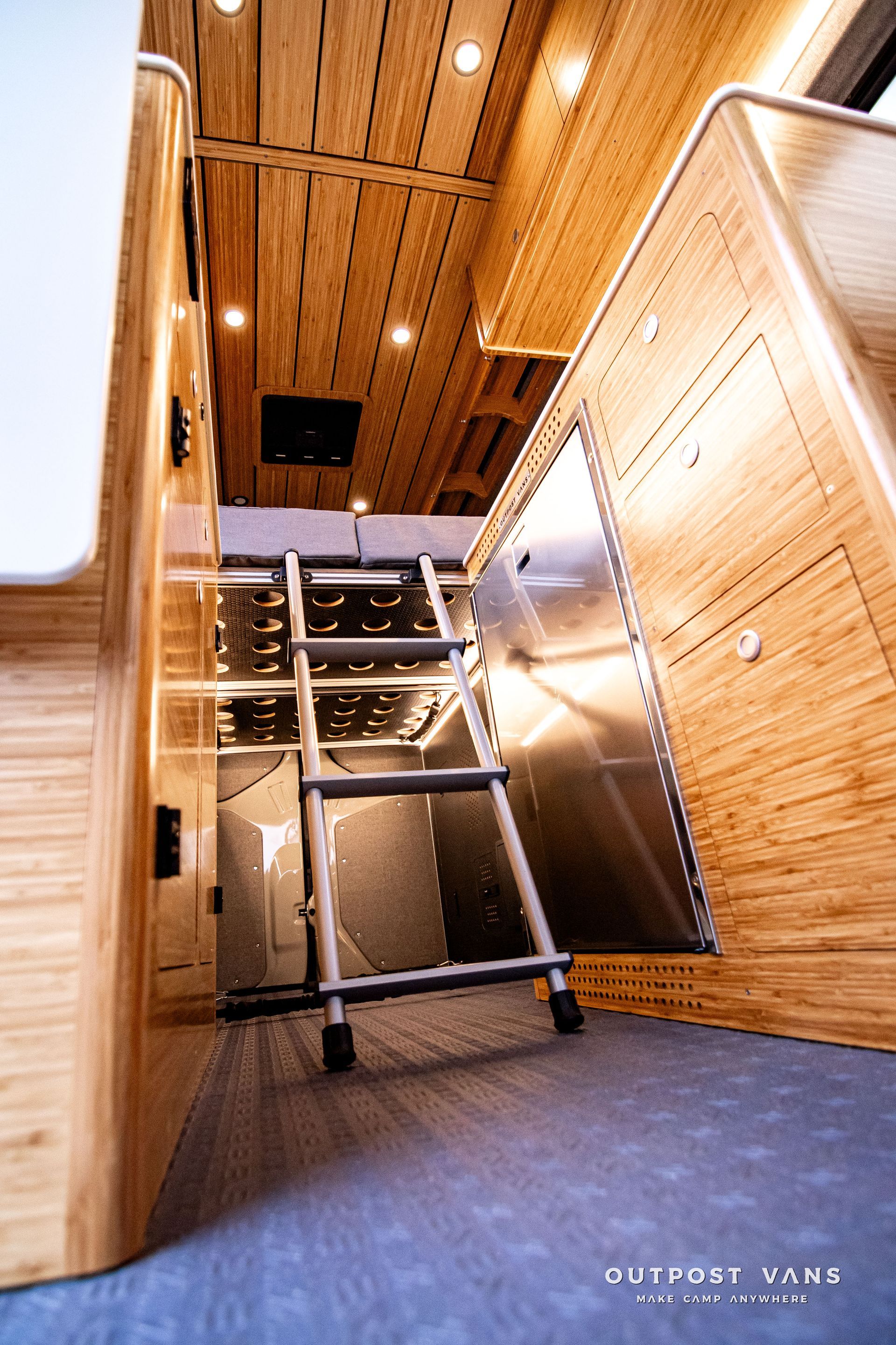 A ladder is going up to the ceiling of a van.