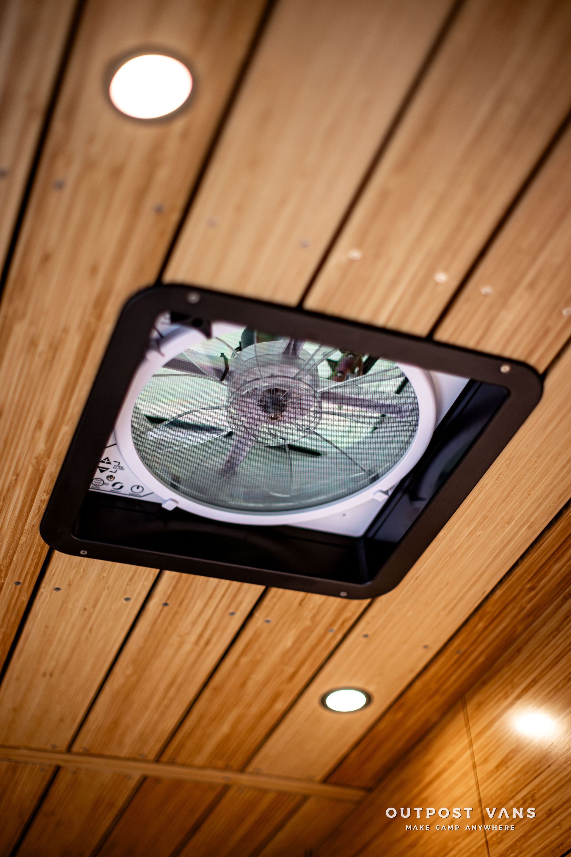 A fan is mounted to the ceiling of a wooden room.