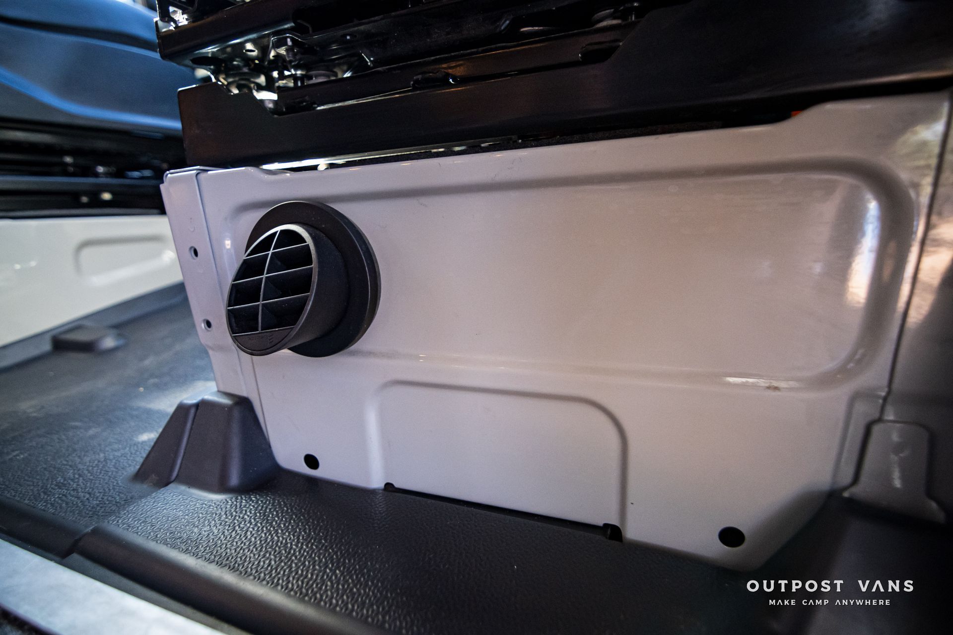 A close up of a heater in the back of a car.
