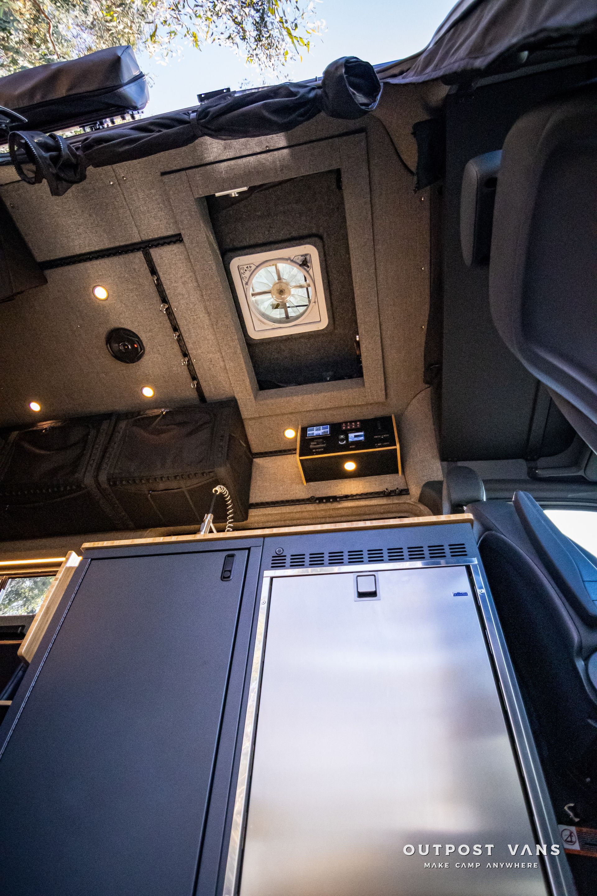 Looking up at the ceiling of a camper van with a skylight.