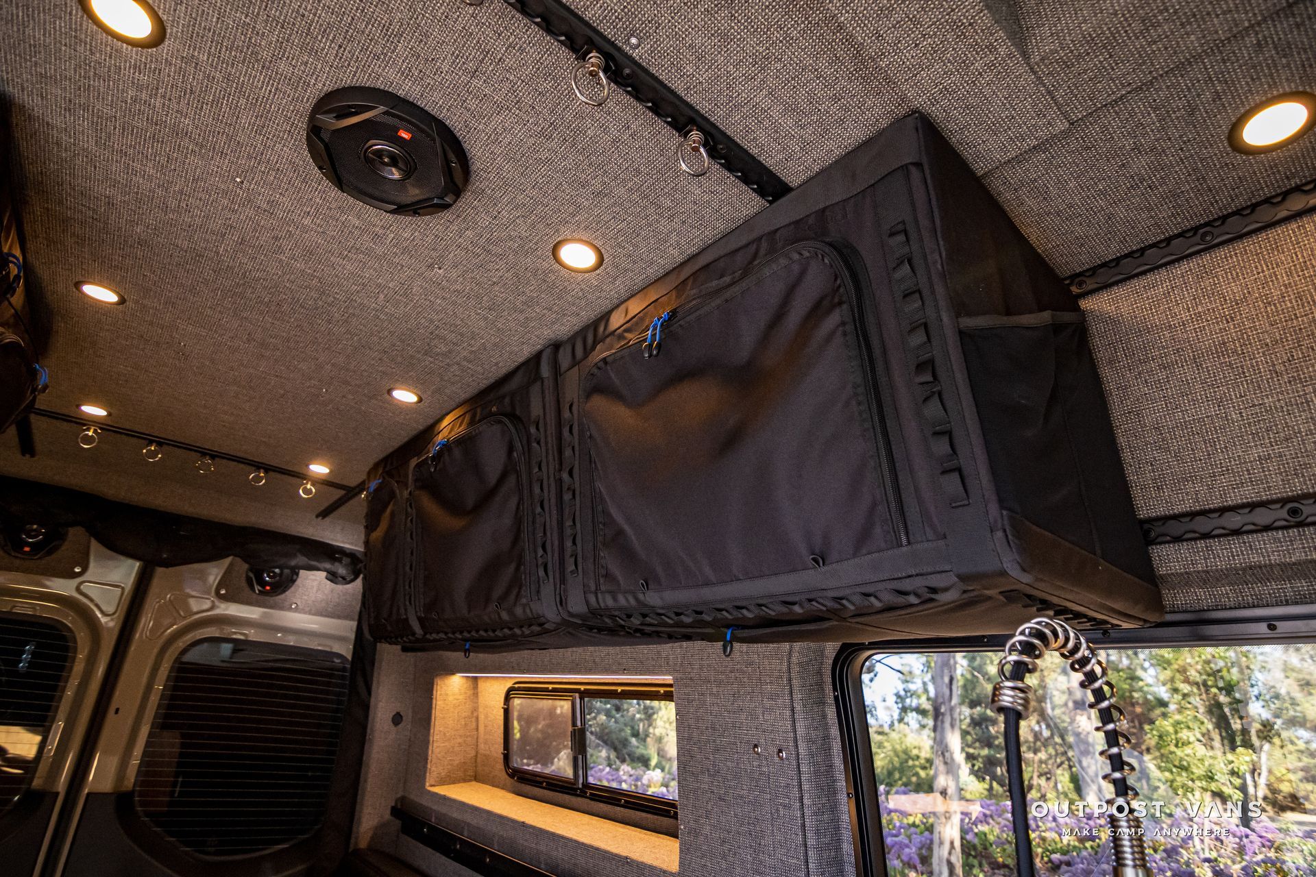 The inside of a camper van with a rooftop tent.