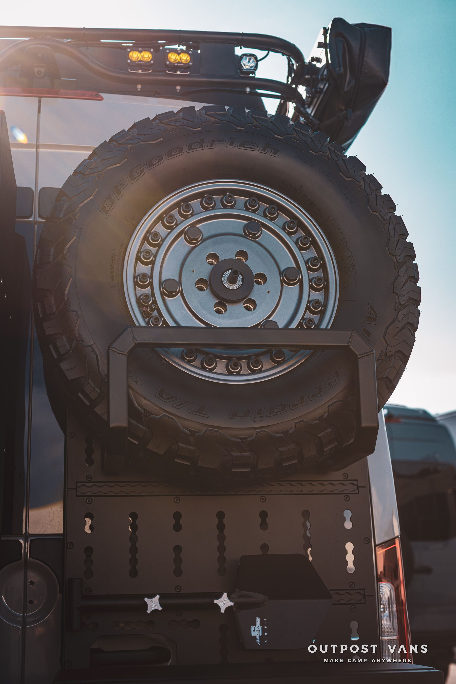 A close up of a tire on the back of a truck.