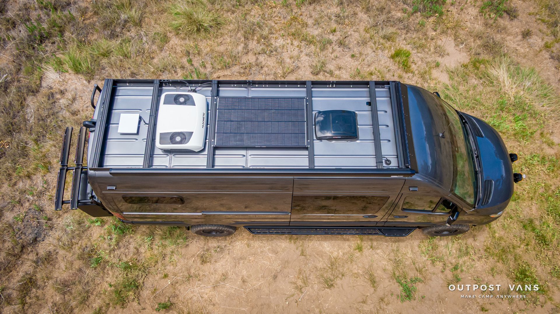An aerial view of a van with a solar panel on the roof. Outpost vans Sprinter 170 AWD.