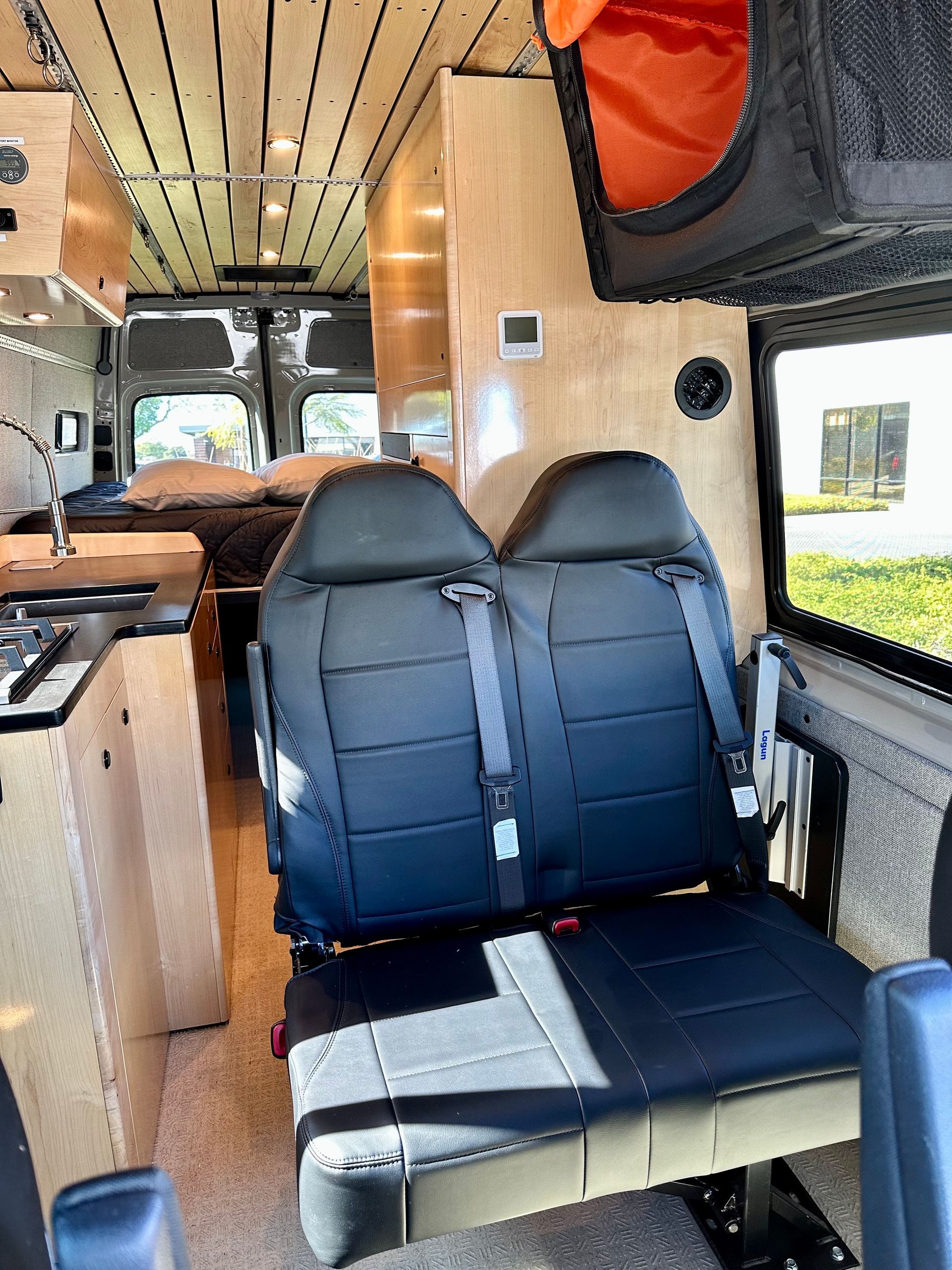 the inside of a van with two seats and a bed .