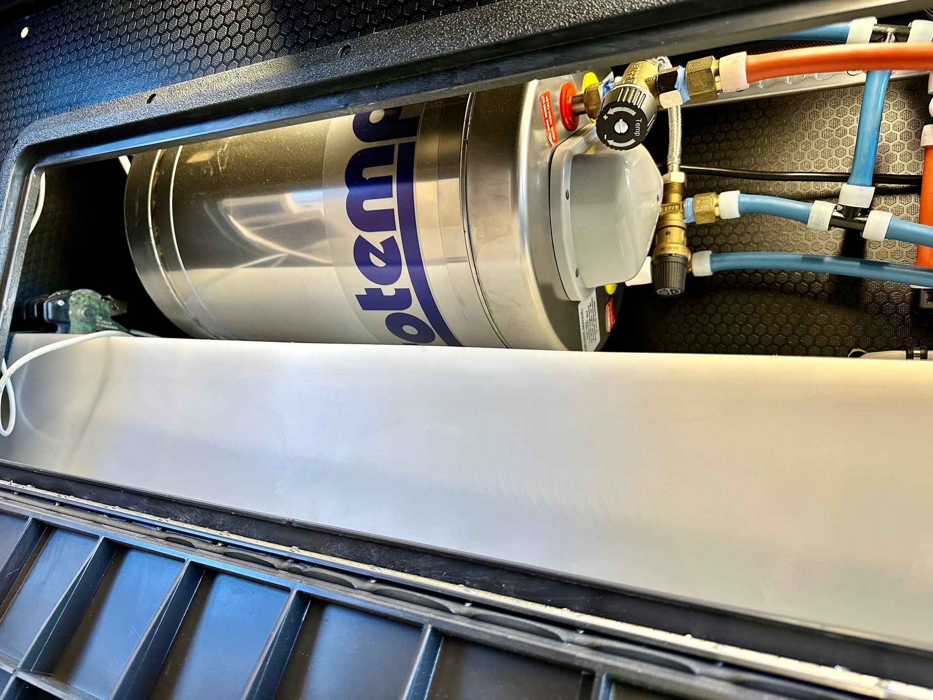 a water filter is sitting inside of a metal box .