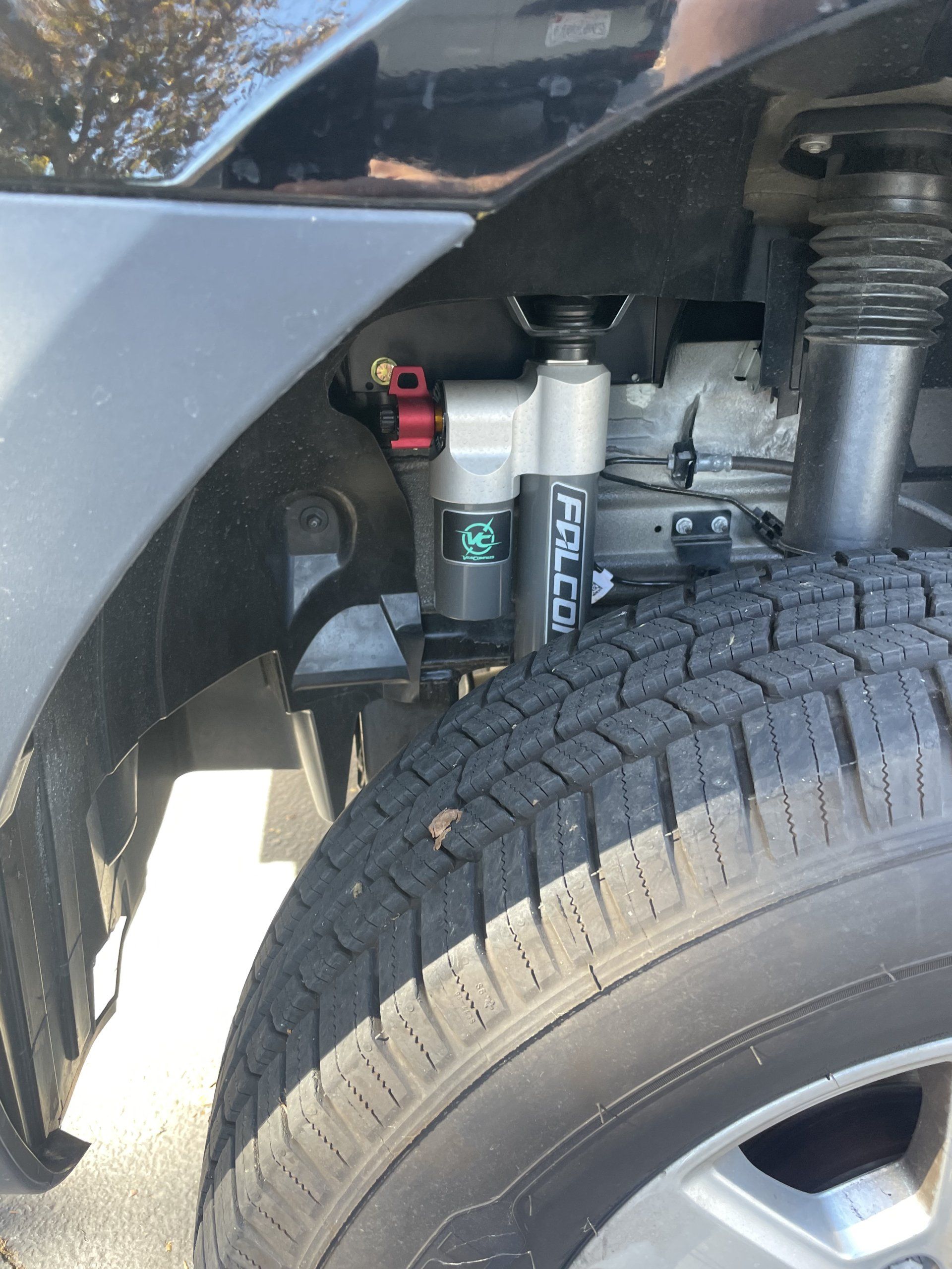 A close up of a car 's tire and shocks