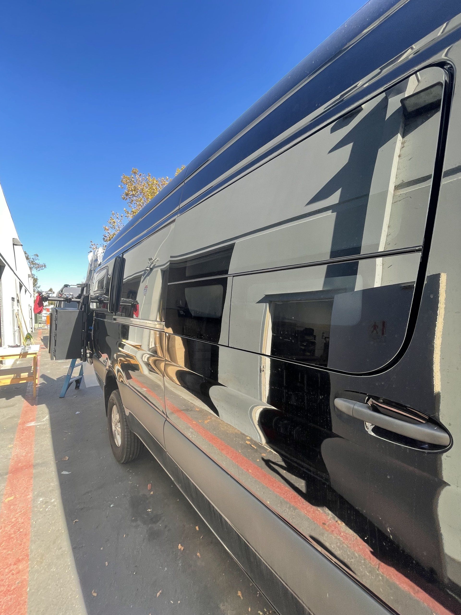 A black van is parked on the side of the road