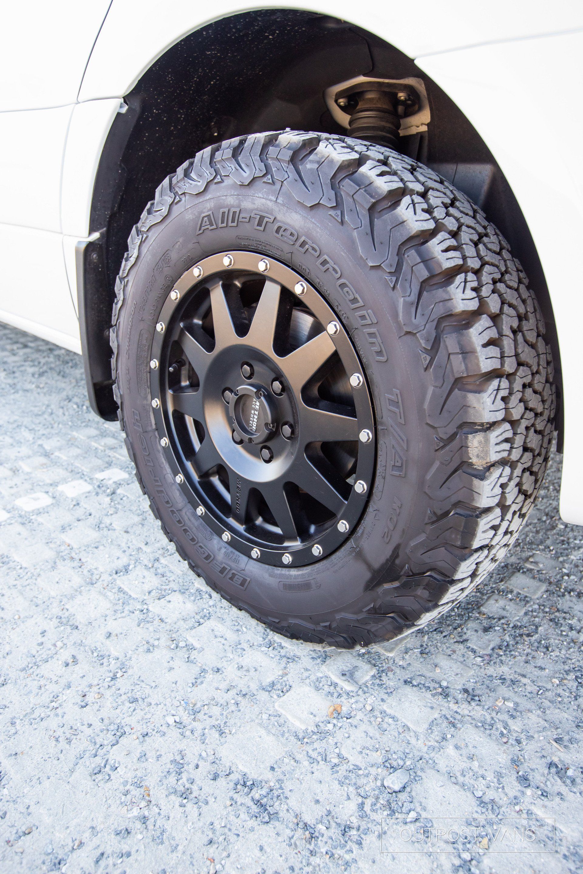 A close up of a tire on a white car.