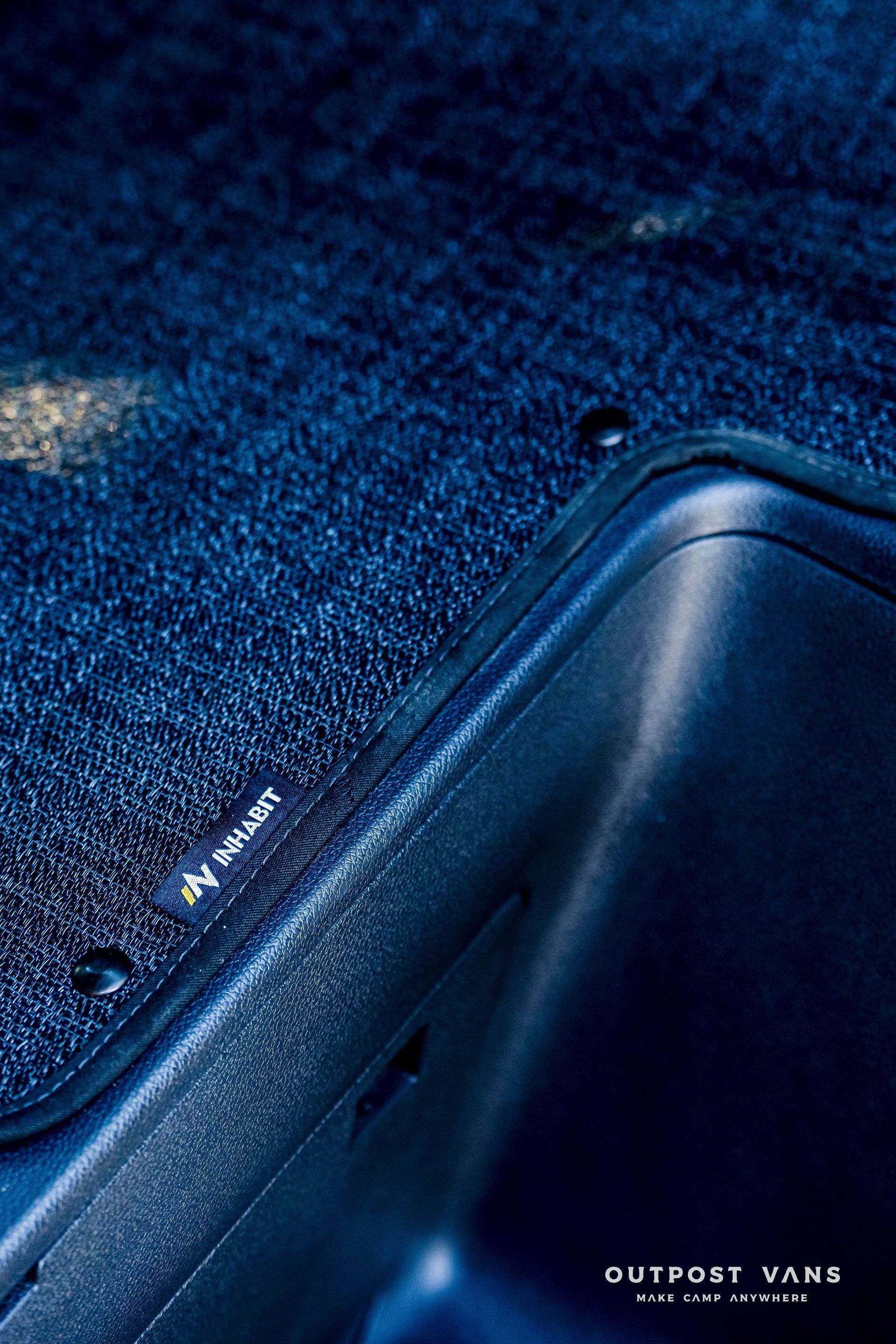 Dark blue textured surface, corner of a container, with