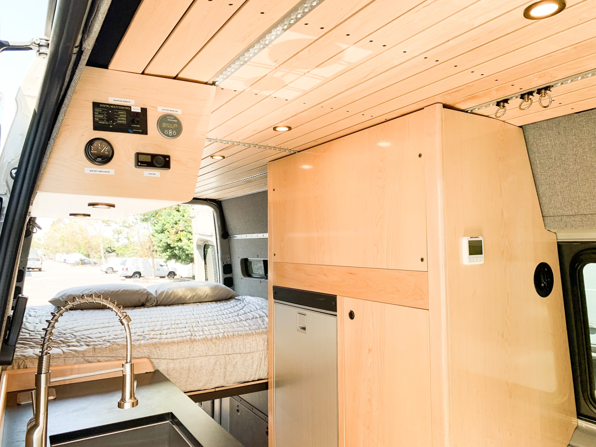 a van with a bed and a sink in it .