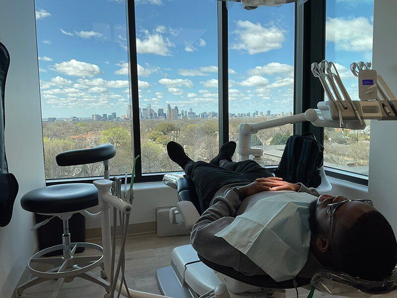A dental patient sitting in a modern Lakewood Dental Studio room.