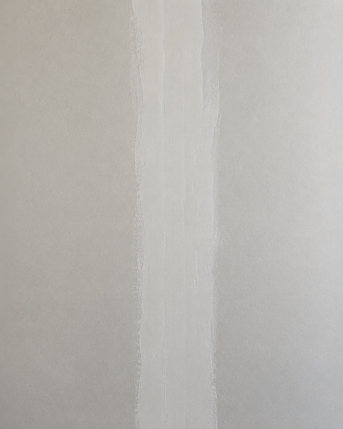 Close-up detail of a clean drywall joint seam mudded and ready for base priming.