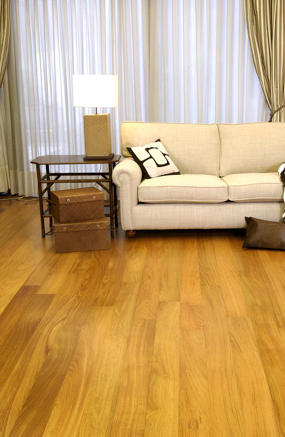A Space Featuring Floating Floors And A White Sofa — Flooring Direct Mid North Coast in Nambucca, NSW