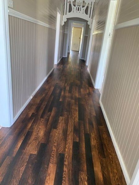 A Long Hallway With A Wooden Floor And White Walls — Flooring Direct Mid North Coast in South Kempsey, NSW