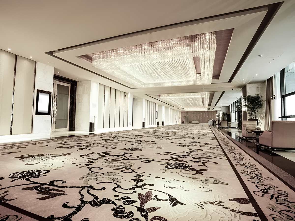 A Lengthy Corridor With Carpeted Floors And A Chandelier Above
— Flooring Direct Mid North Coast in Nambucca, NSW