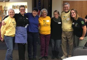 The Mueller staff standing with Yellow Ribbon Network volunteers 