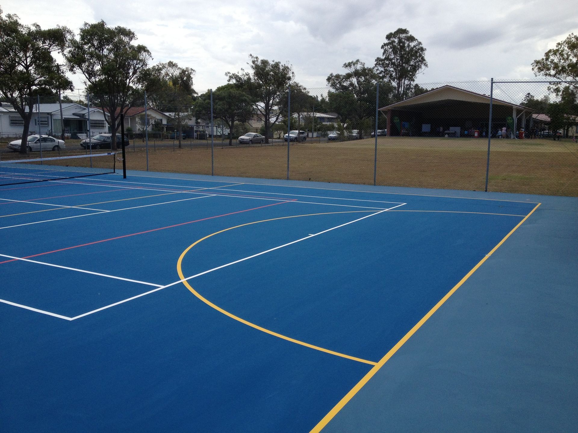 Blue Basketball Court with a Yellow Line in the Middle — Queensland, Australia — Jordin Sports Constructions
