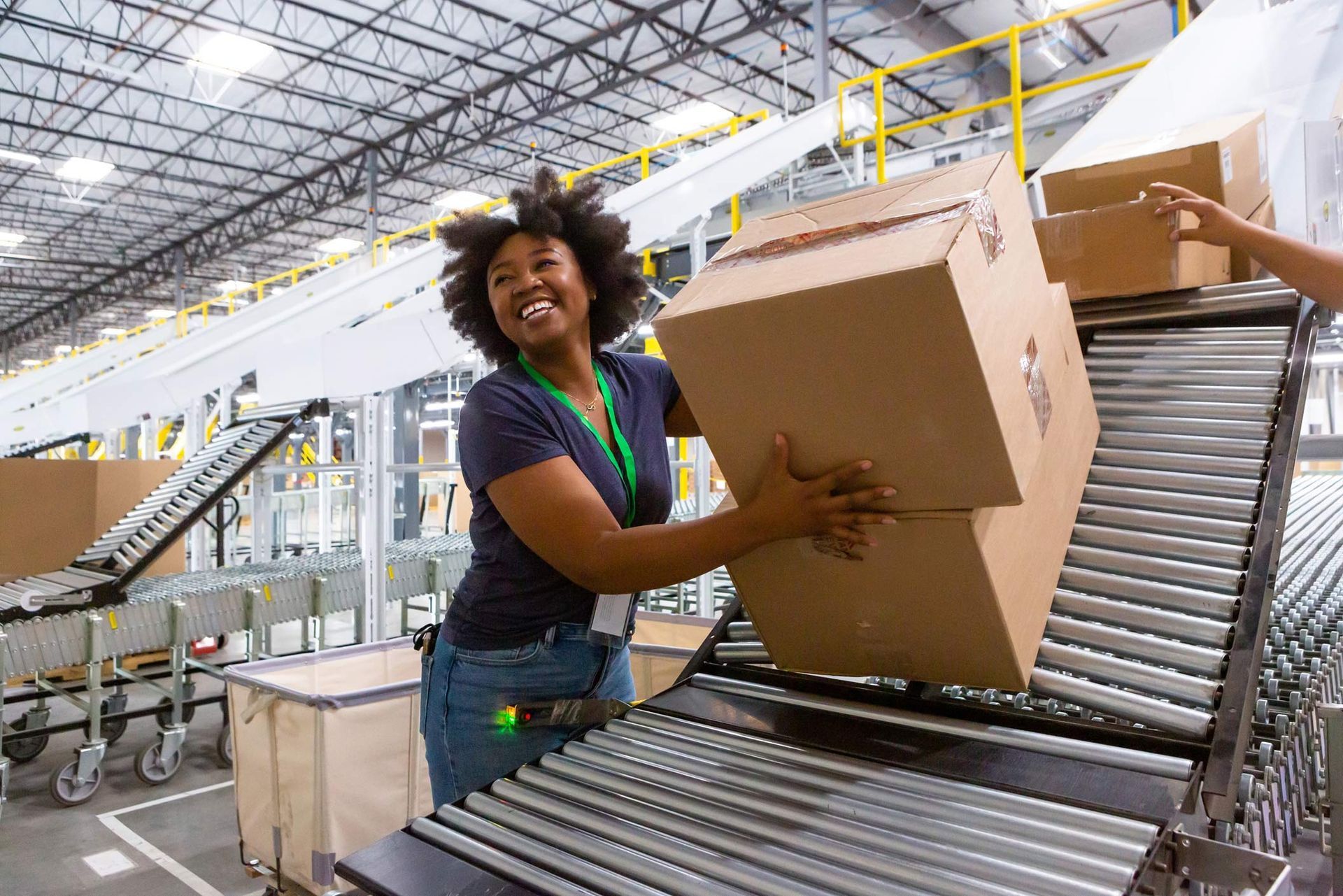 A cheerful warehouse employee is loading boxes into a truck, showcasing general labor jobs. A cheerful warehouse employee is loading boxes into a truck, showcasing general labor jobs.