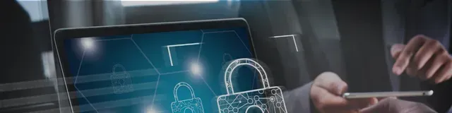 Hands using a laptop with a glowing padlock security icon on the screen