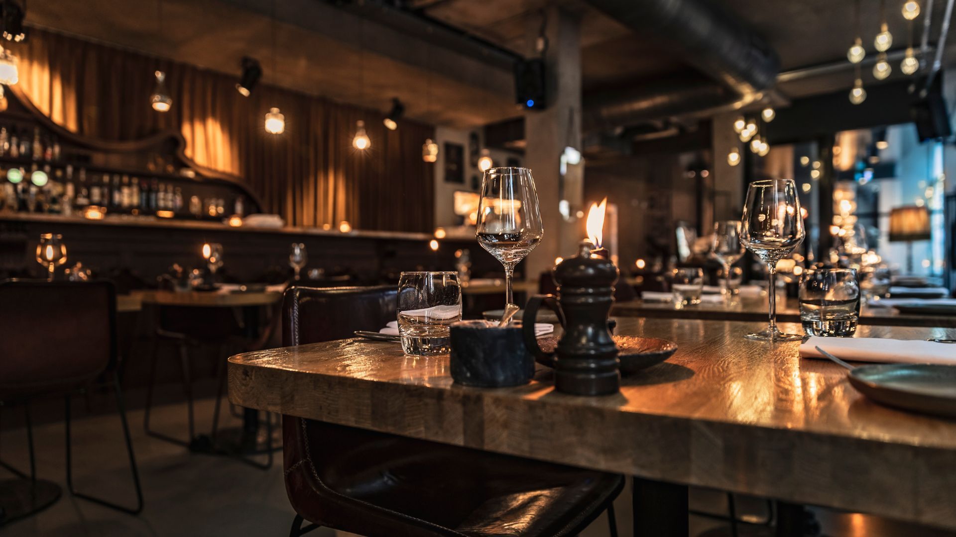 A restaurant with tables and chairs set for a dinner party.