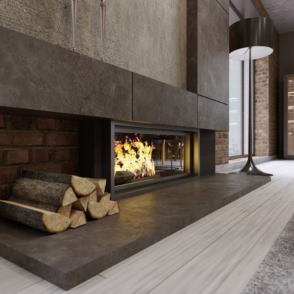 Modern living room fireplace with burning logs, stacked firewood, and sleek gray stone surround