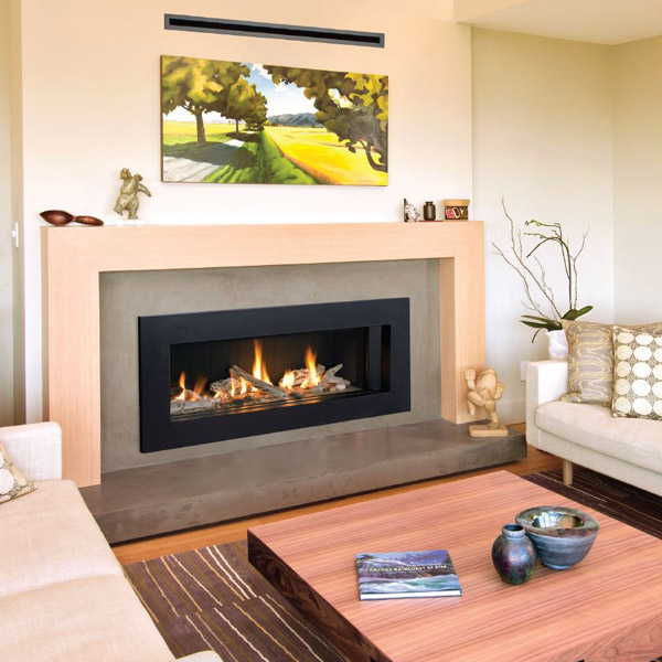 Modern living room with a fireplace, framed landscape art, and a wooden coffee table