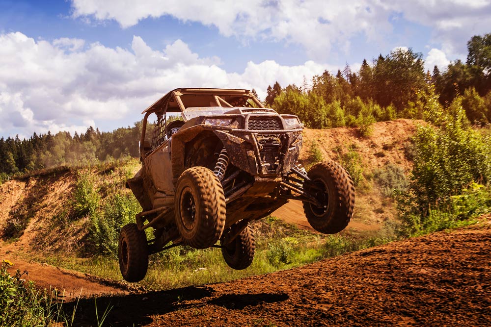 A Dirt Bike is Jumping in the Air on a Dirt Road — SVS Auto Repairs & Dyno Tuning in Cairns, QLD