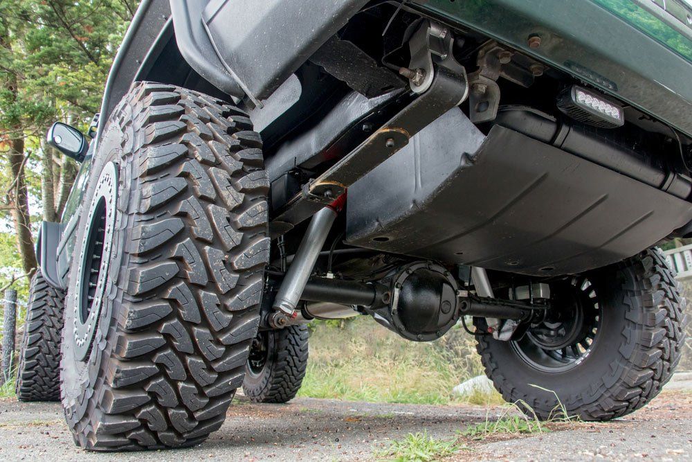 A Close Up of the Underside of a Truck With a Large Tire — SVS Auto Repairs & Dyno Tuning in Cairns, QLD