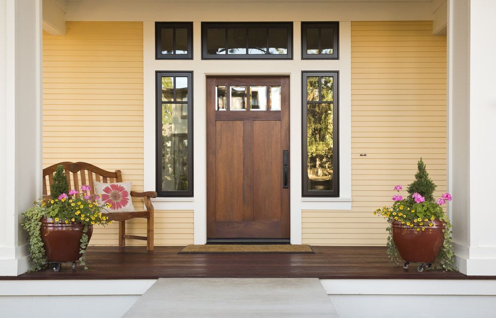 A Front Porch Of A House With A Wooden Door  — Hitek Frame & Truss In Cobar, NSW