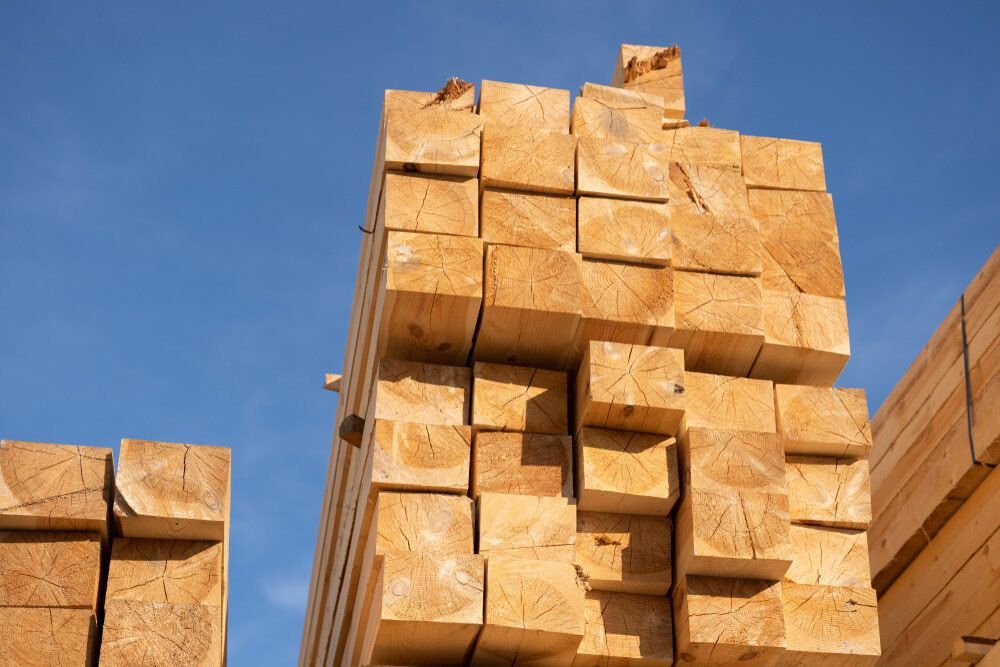 A Stack Of Wooden Blocks Against A Blue Sky — Hitek Frame & Truss In Brewarrina, NSW
