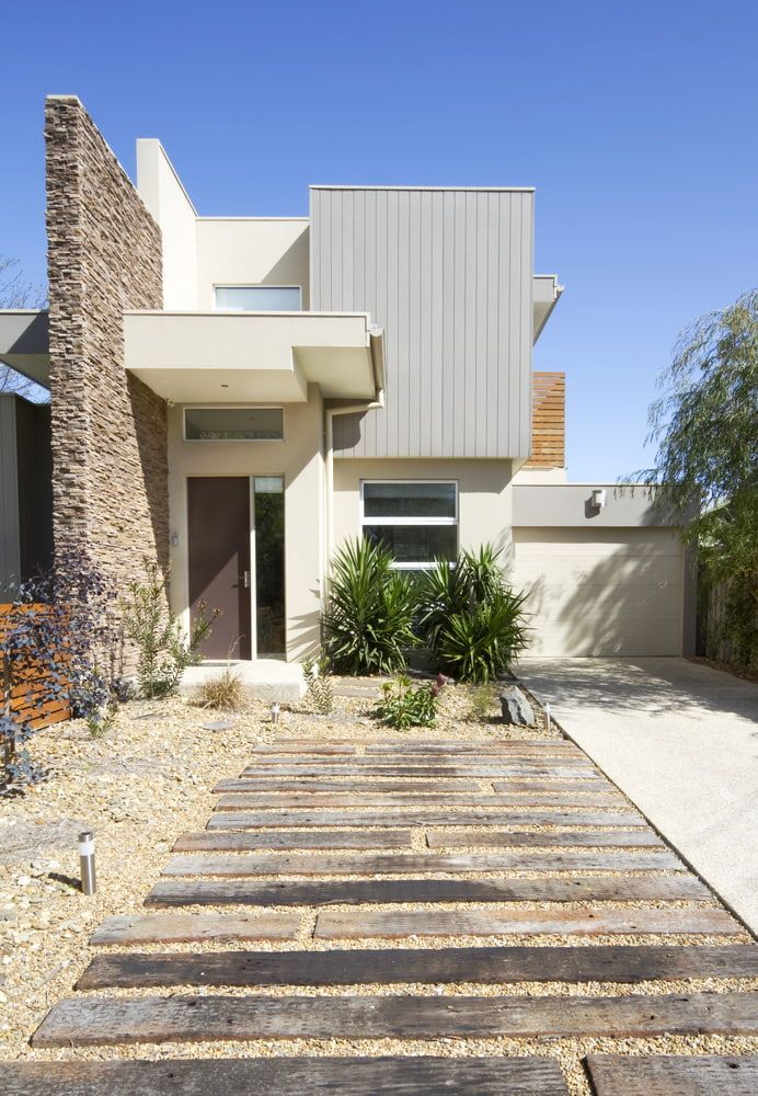 A Modern House With A Wooden Driveway Leading To It — Hitek Frame & Truss In Warren, NSW