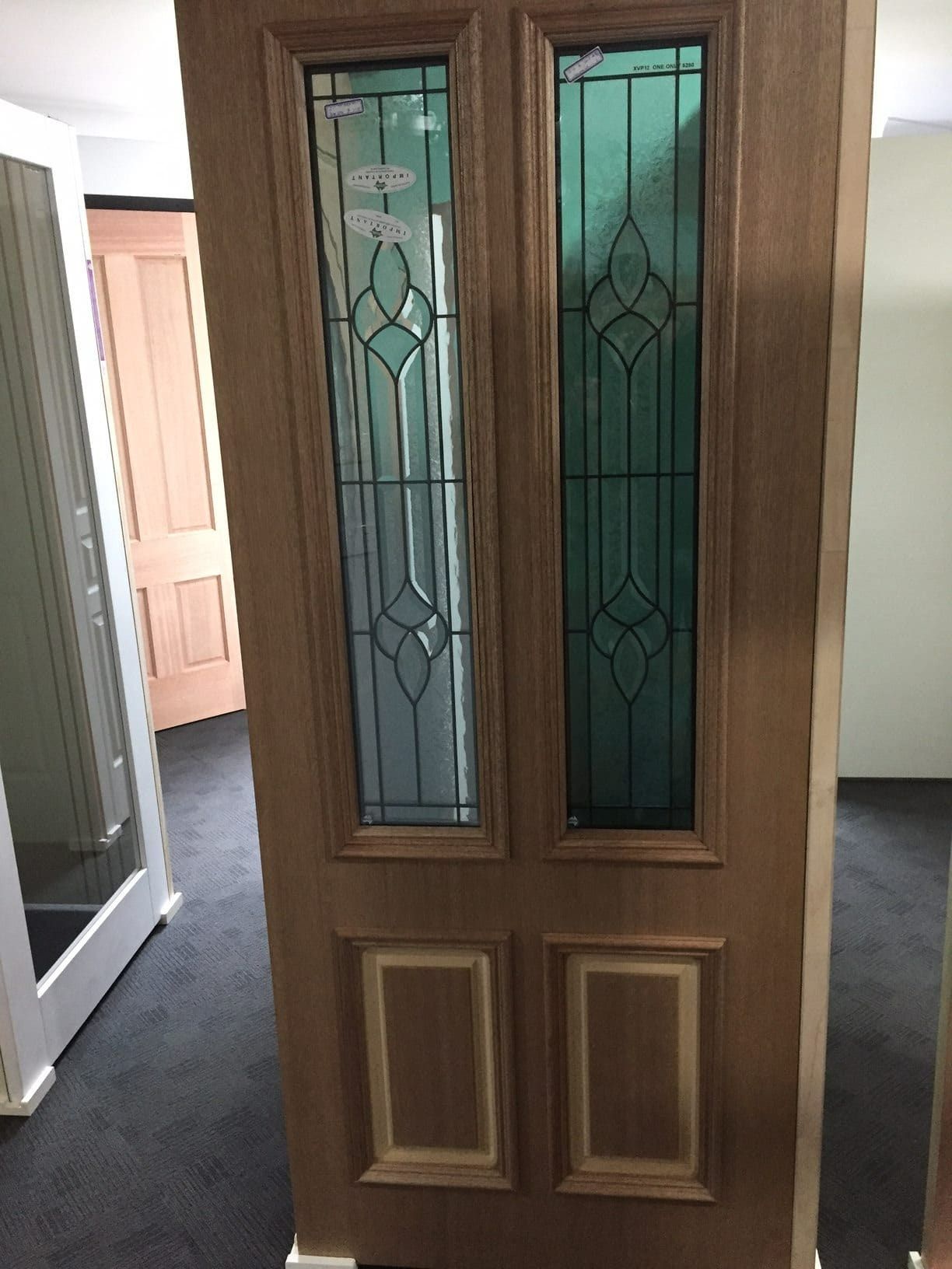 A Wooden Door With Stained Glass Windows In A Room — Hitek Frame & Truss In Brewarrina, NSW