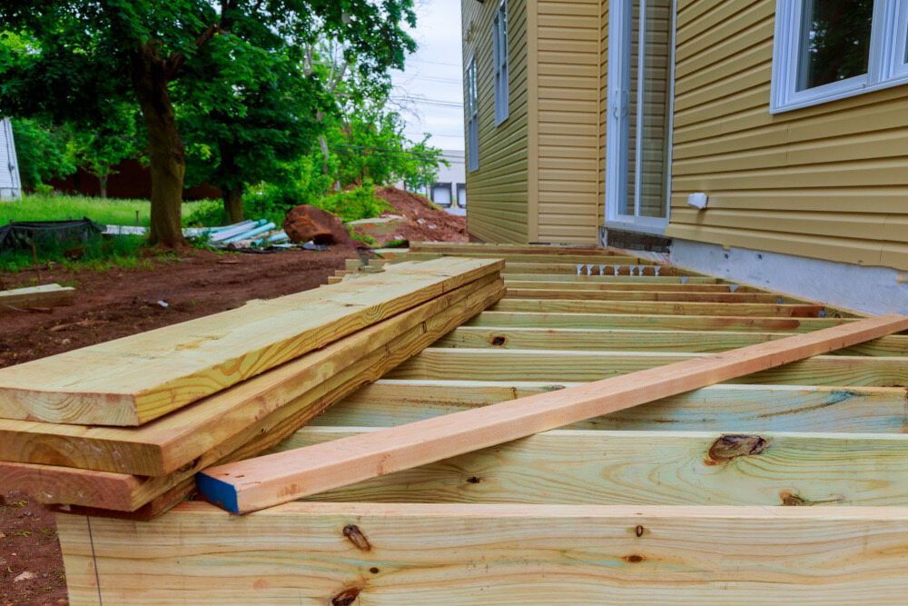 A Wooden Deck Is Being Built In Front Of A House — Hitek Frame & Truss In Warren, NSW