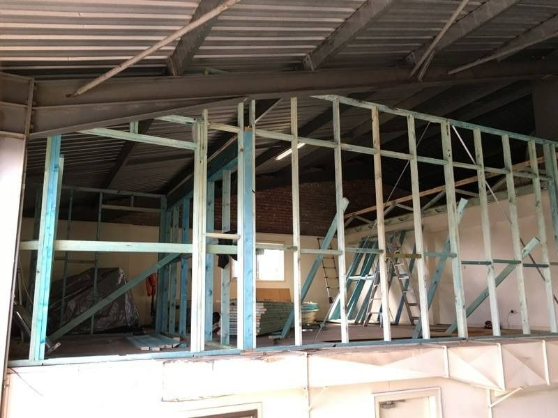 A Building Is Being Built With Wooden Beams And A Ladder — Hitek Frame & Truss In Dubbo, NSW