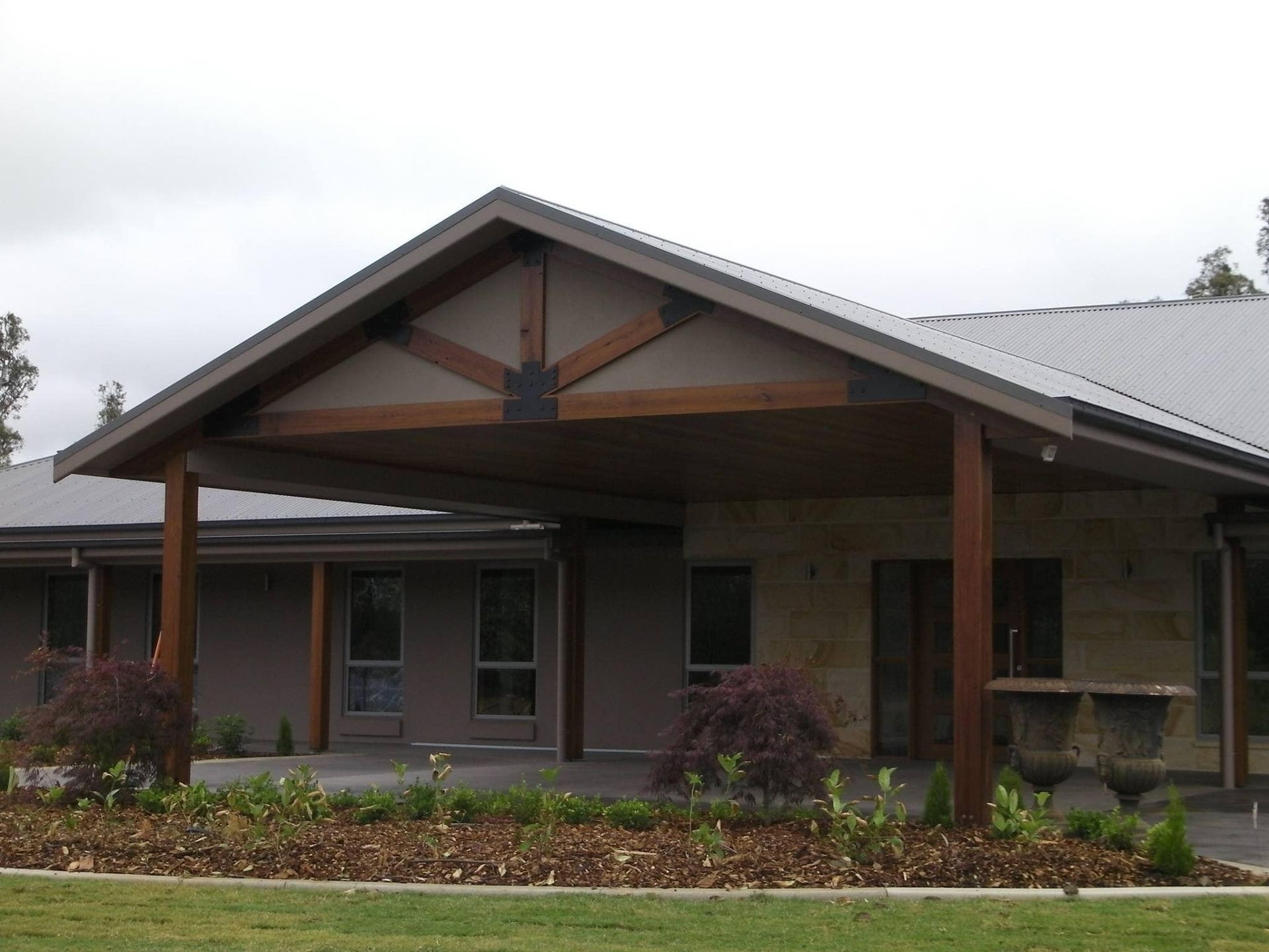 A House With A Wooden Porch And A Gray Roof — Hitek Frame & Truss In Cobar, NSW