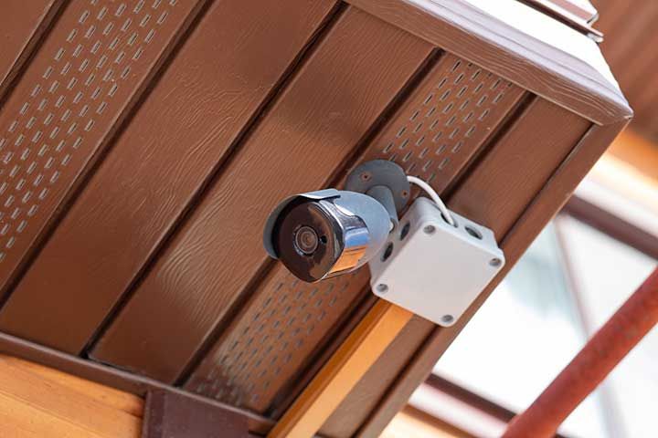 Security camera mounted on brown ceiling