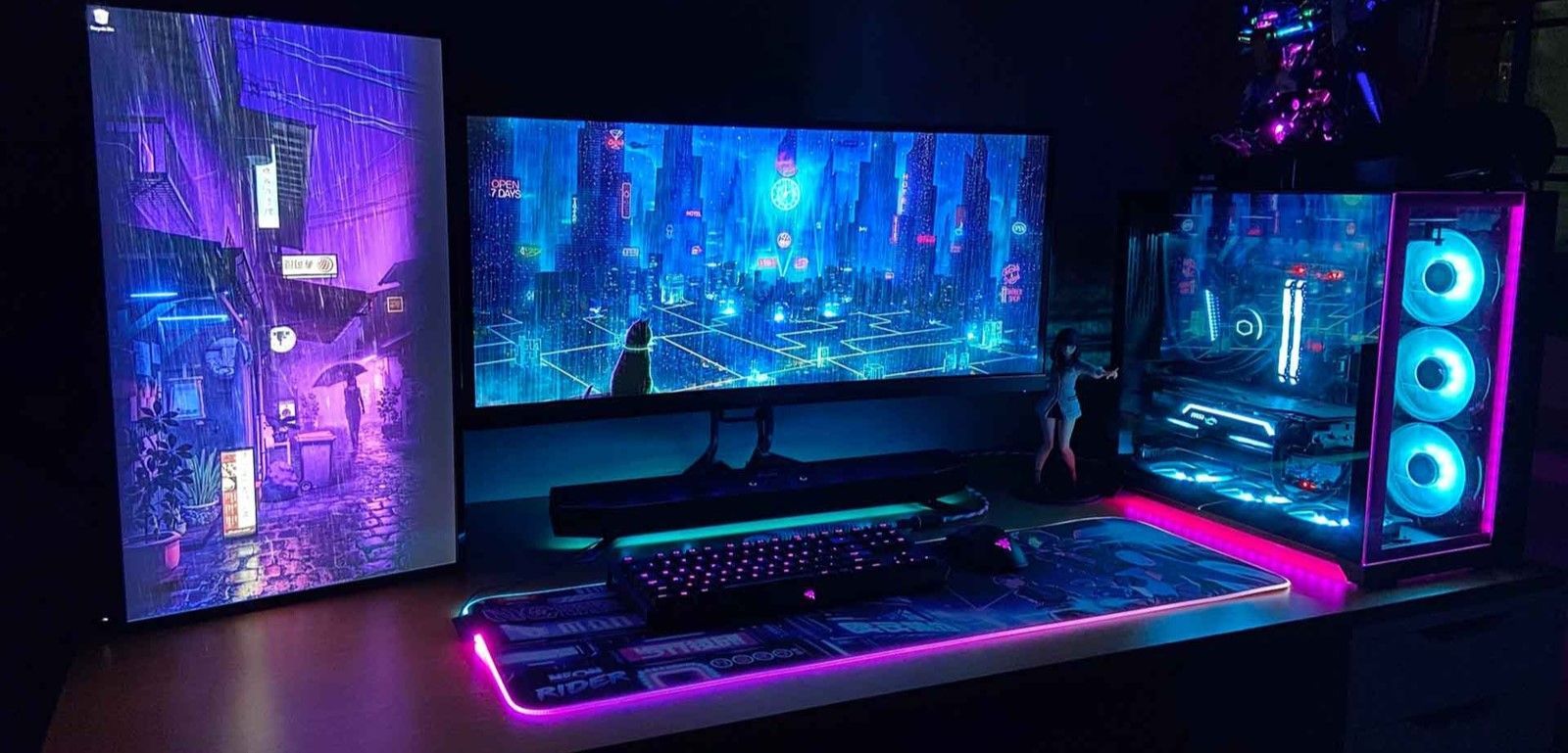 A computer setup with a monitor , keyboard , mouse pad and speakers.