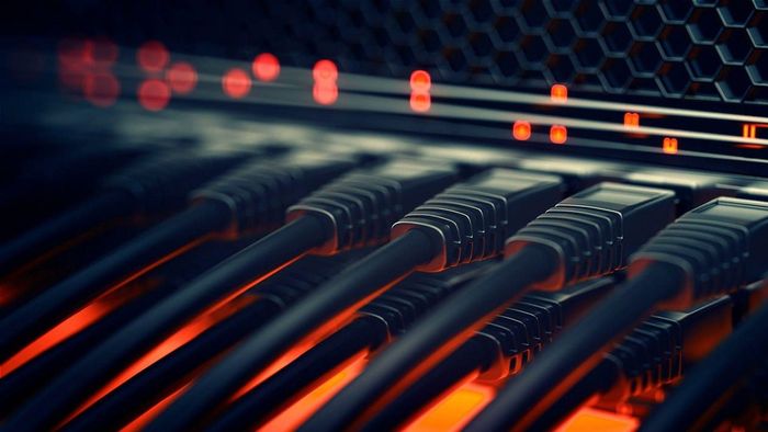 A bunch of ethernet cables are connected to a server.